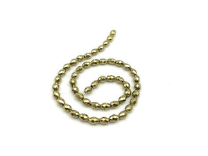 Hematite Coated Light Gold Faceted Rice 6X9Mm